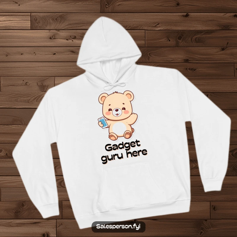 Funny hoodie with a small, smiling bear enthusiastically offering a shiny new electronic gadget.