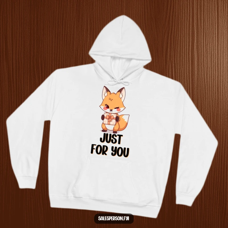 Funny sly fox hoodie graphic, featuring a playful wink and a gift box, ideal for cozy, humorous wear.