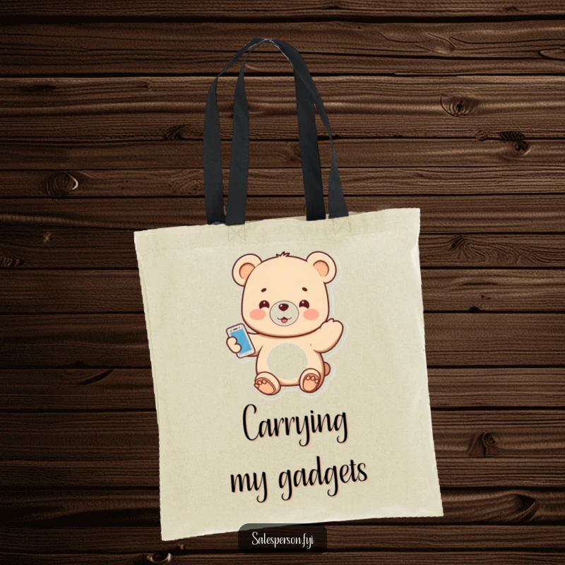 Funny tote bag featuring a small bear enthusiastically presenting a shiny new gadget.